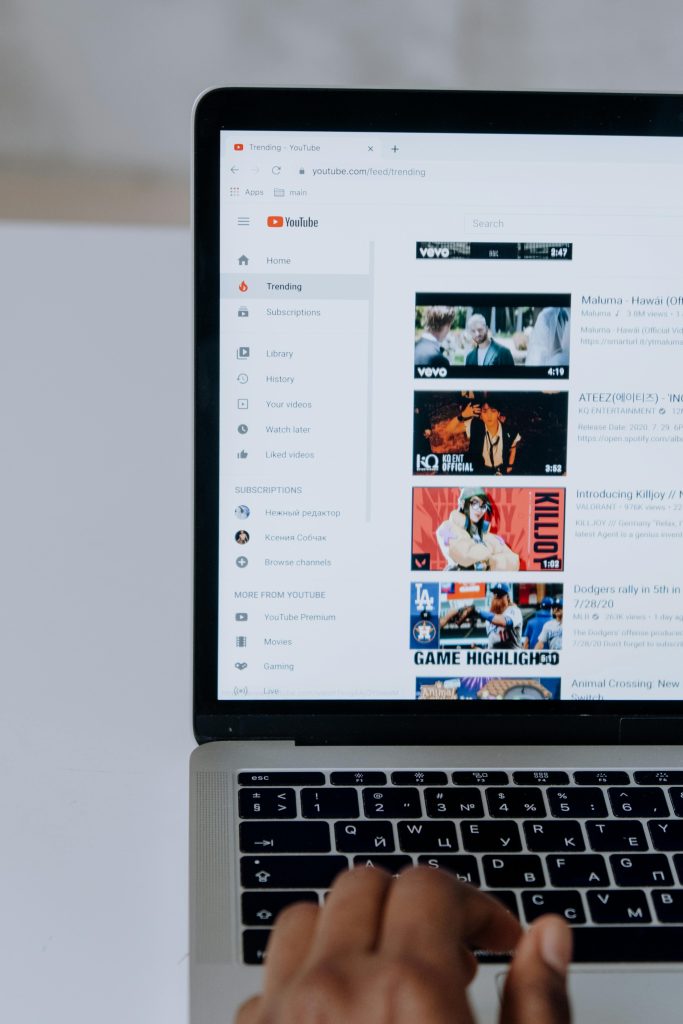 pexels-photo-5077064-5077064 Person browsing YouTube videos on a laptop, showcasing modern technology and online content.